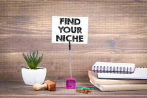 Find your niche. Wooden table with stationery