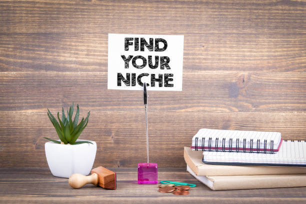 Find your niche. Wooden table with stationery