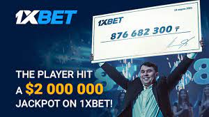 1XBet winning player man holding big check above his head