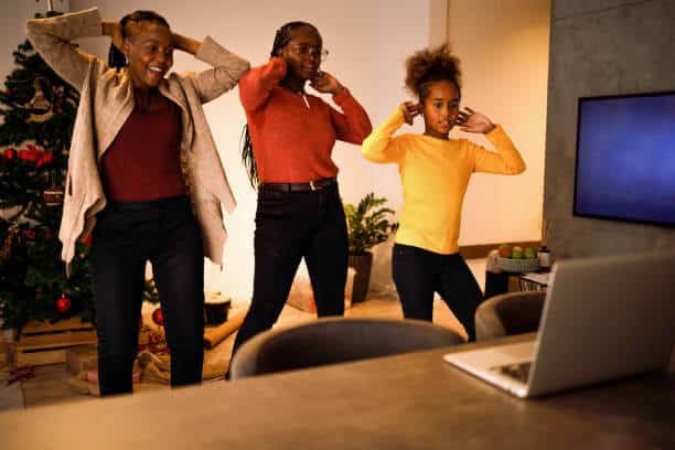 Three female members of an African American family have lots of fun dancing TikTok routines on Christmas day.